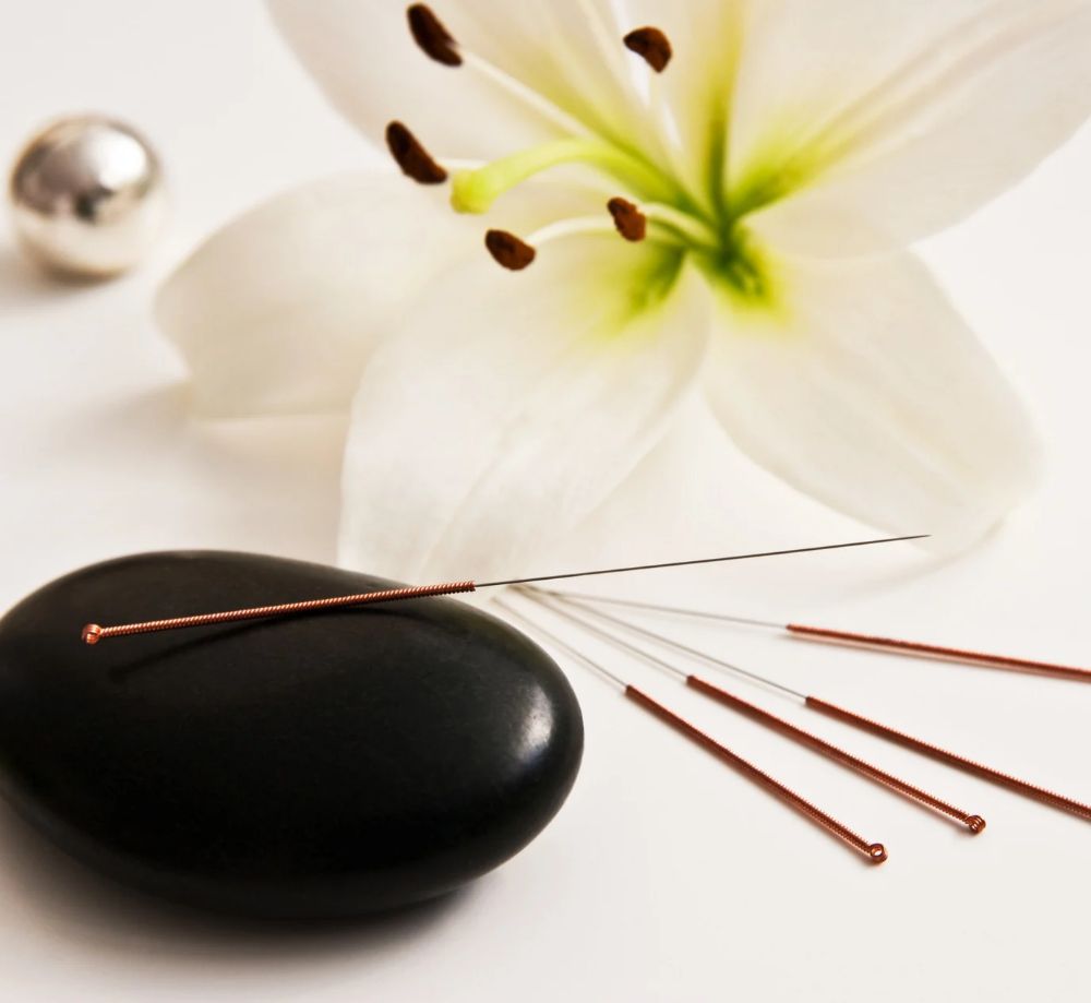 Acupuncture Needles on a Wooden Mat What Is Acupuncture and How Does It Work?