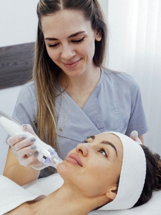 Woman Receiving Microneedling Facial Treatment